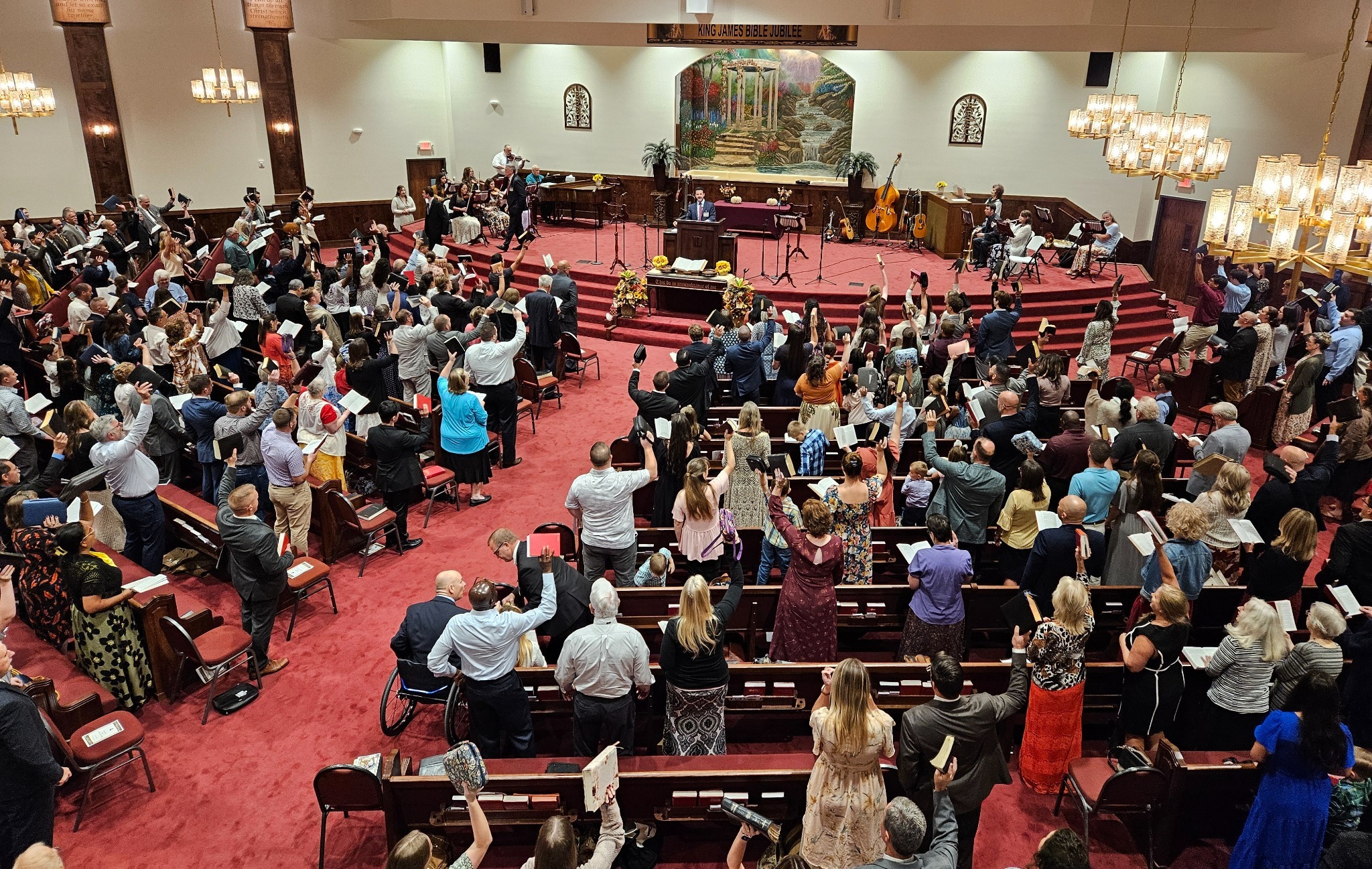 The congregation singing and holding Bibles during a church service